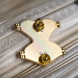 Back of gold hard enamel pin shows the two butterfly clasps and the magnets on the back to keep the pin closed.