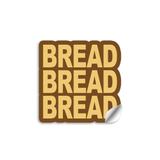 3" vinyl die cut sticker with bold block text. A Brown sticker with yellow-tan text says "BREAD BREAD BREAD".