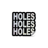 3" vinyl die cut sticker with bold block text. A Black sticker with glittery text says, "HOLES HOLES HOLES".