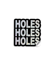 3" vinyl die cut sticker with bold block text. A Black sticker with glittery text says, "HOLES HOLES HOLES".