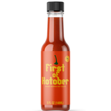 A glass 5oz bottle of red hot sauce with a label that reads "First of Hotober; Ghost Pepper Hot Sauce". From Rob Scallon.