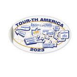 An oval shaped white decal showing different cities around the world with the text "Tour-th America 2023".