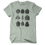 Light green short sleeve shirt with printed design of scientifically illustrated trees in black ink. Text on bottom written in script reads "At least there are tress"