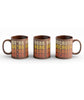 Brown Mug with a full wrap design. Design is of lettering saying, "We're Here Because" repeated four time in 70's style lettering. Lettering color is an off white for the first line, yellow for the second line, orange for the third line, and red for the fourth line. 