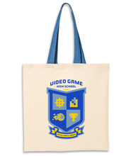 Natural colored tote with blue strap and Video Game High School Crest in Blue and yellow printed in the center.