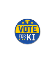 Blue metal circular pin with the words "VOtE FOR KI" with yellow stars.