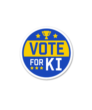 Circular sticker with the words "VOTE FOR KI" with yellow stars.