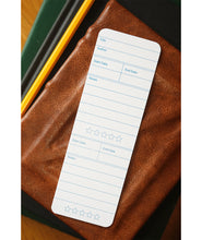 A bookmark with the front design displayed. The design features fields for readers to write about the book being read.