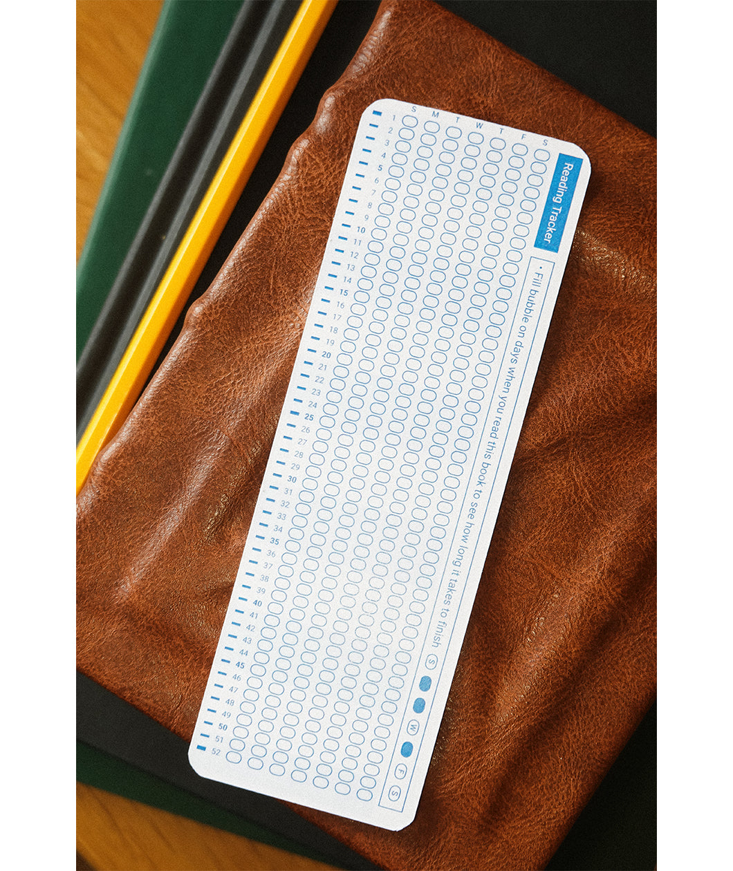 A bookmark with the back design displayed. The design features a reading tracker for readers to mark days they read.
