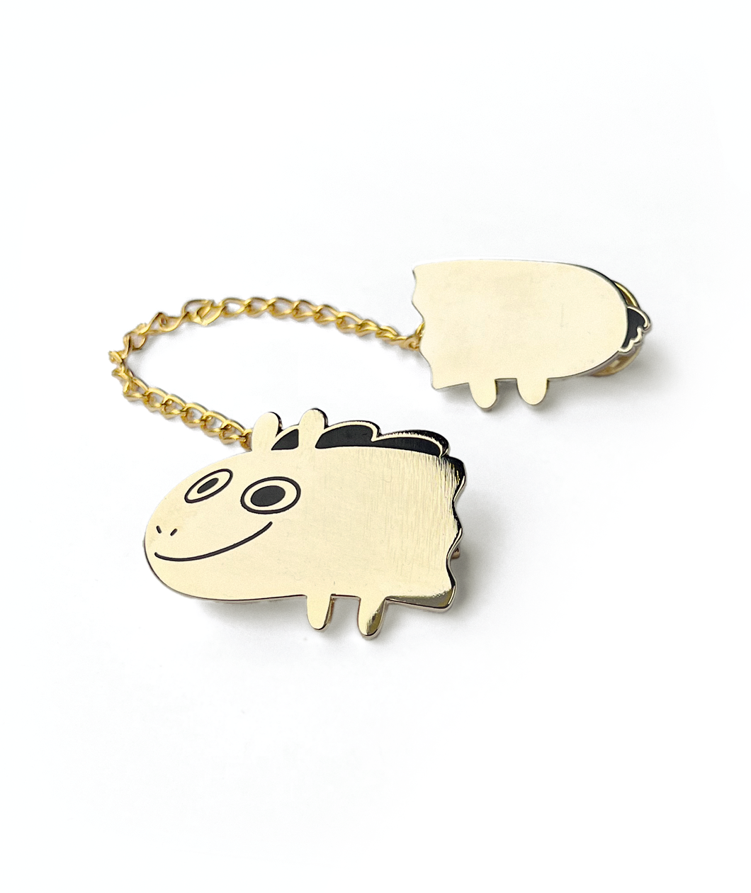 Two pieces of a golden pin that are attached by a gold chain. The front of the pin is the head of Jacob Horse and the other is the back half. From Drawfee.