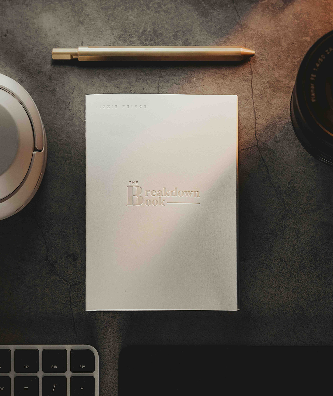 A white notebook with the text "The Breakdown Book" on the front from Lizzie Peirce.