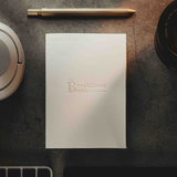 A white notebook with the text "The Breakdown Book" on the front from Lizzie Peirce.