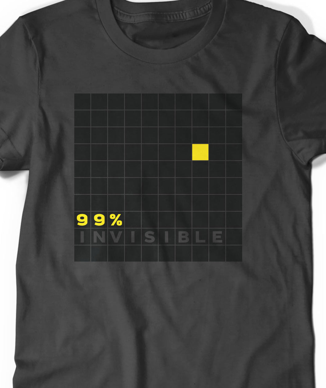 Close-up on grey t-shirt with large grid of all black squares except for 1 yellow and the words "99% Invisible" in yellow and grey - by 99% Invisible 