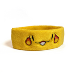 A yellow sweatband with a smiling face that has a fireball on the side of each eye - by Brian David Gilbert