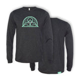 A gray long sleeve shirt. In the center, a green outline vector drawing of a sun rising above a mountain with a half circle around both. “G” and “R” are in white on either side of a green tree - from the Ginger Runner