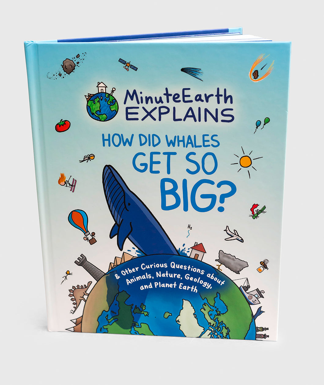 A book titled "Minute Earth Explains; How did whales get so big?" with an illustration of earth with a large whale coming out of the top and other symbols like a sun, airplane, a house, a cast, a dinosaur, etc.