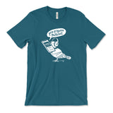 A dark teal t-shirt with a white, illustrated pigeon holding a phone in its mouth, waring headphones with a speech bubble that says "pro-pigeon podcast". From the Newest Olympian.