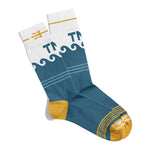 A pair of socks that are mostly blue with breaking waves at the top of the socks. The very top of the socks are white with a yellow trident and the letters "TNO". The heal and toe of the sock are yellow with white text that reads "The Newest Olympian".