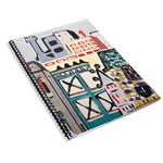 A spiral bound notebook with drawn, colorful buildings on the cover. From Rob Scallon.