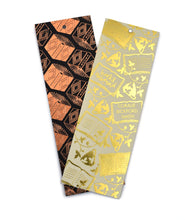 Two bookmarks in repeating patterns, one in gold with open books and one in black and orange.  