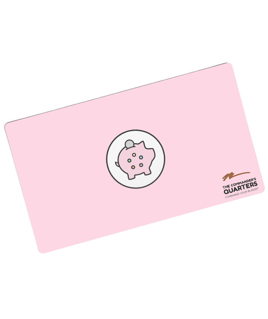 A pink rectangular playmat with curved corners. In the center is a white circle with a black outline. A piggy bank is in the center with a coin being inserted. On the pig are five circles of different colors. “The Commander’s Quarters” is in the bottom right in black sans serif font with a signature above - from The Commaner’s Quarters