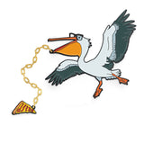 A pin shaped link a pelican wearing glasses (meant to look like Hank Green) with a golden chain attached to its lower bill that connects to a slice of pizza with "dftba" written on it.