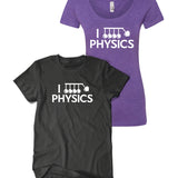 Black shirt and purple curved cut shirt both with “I” in white sans serif font followed by a vector drawing of Newtons cradle. A heart takes the place of one of the balls. Below, “Physics” is in white sans serif font - from Physics Girl