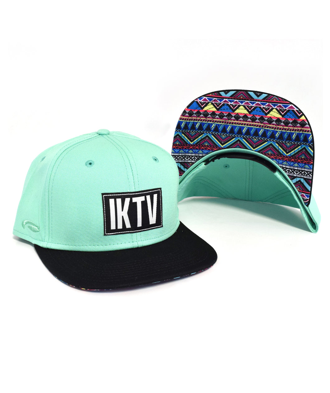 Aqua trucker hat with a black square on the front with white letters "IKTV." The bill is black on the top and has a blue, red, and yellow pattern on the bottom. By Charles Trippy