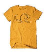 Yellow shirt with cartoon, black line drawing of porcupine eating a banana all with yellow fill. "Kemosabe” is written in black sans serif font in bottom left of porcupine. "Coendou prehensilis” is below in cursive black font.” On right, black line leads from mouth with “nom nom” in black sans serif font - from Animal wonders