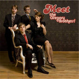 An album cover featuring four people posed in suits and a dress. On the cover it reads "Meet the Gregory Brothers!".