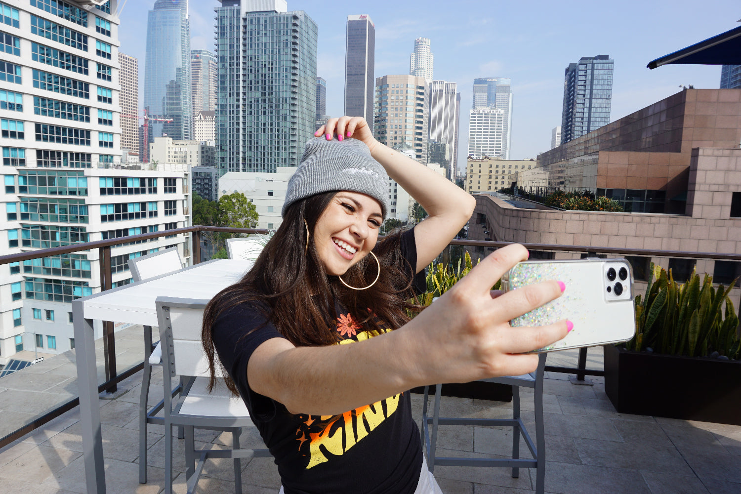 A woman modeling a gray beanie with “confident & kind” in white cursive font across the cuff - from Sierra Schultzzie