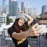 A woman modeling a gray beanie with “confident & kind” in white cursive font across the cuff - from Sierra Schultzzie