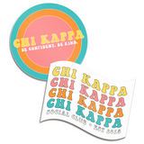 Two stickers, one is circular with a colorful, ringed background that says "Chi Kappa; Be confident. Be kind." The other is shaped like a flag with a white background with the words "Chi Kappa" repeated four times with "Social Club; Est. 2018" below it. From Sierra Schultzzie.