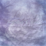A close up of the lavender tie-dye crop top from Sierra Schultzzie, showing the embroidered words "confident & kind".