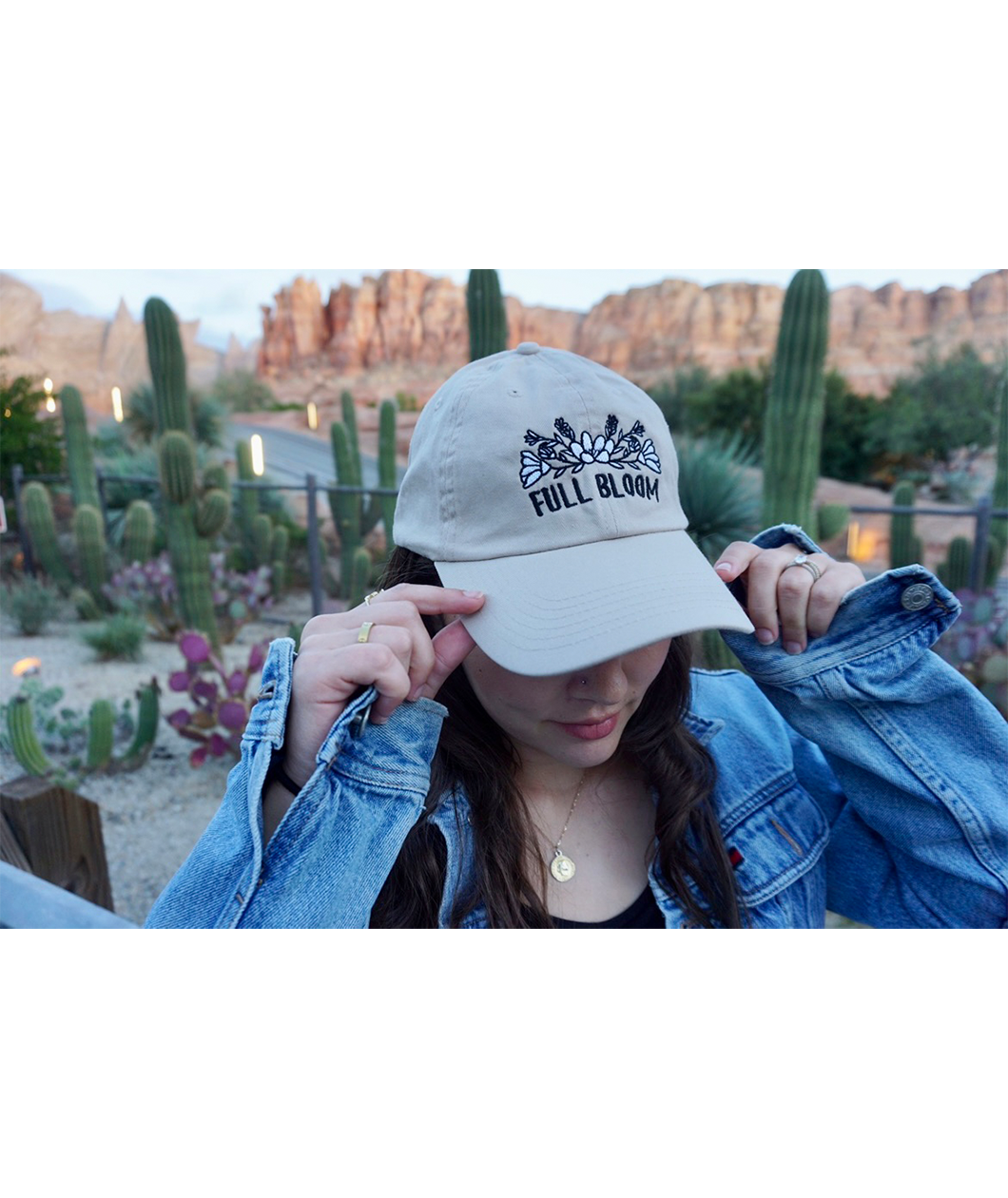 Someone wearing a beige ball cap with the embroidered words "Full Bloom" and flowers. From Sierra Schultzzie.