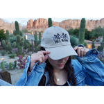 Someone wearing a beige ball cap with the embroidered words "Full Bloom" and flowers. From Sierra Schultzzie.