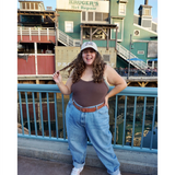 Sierra Schultzzie wearing a beige ball cap with the embroidered words "Full Bloom" with flowers.