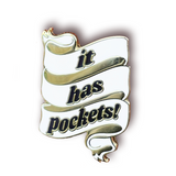 A white ribbon with three folds. Across each fold is one word from the black serif text that says, “it has pockets!” - from Sierra Schultzzie
