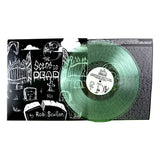 A green vinyl that reads "The Scene is Dead by Rob Scallon". On the left side is a black and white image of a graveyard andon the right is the back of the case featuring lines of small font.