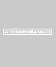 Long rectangular sticker with white border surrounding a white triangle with an exclamation point in the center of it followed by “This Machine Kills Fascists” in white, sans serif font - from John Green