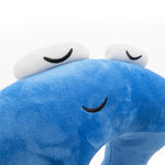 A closeup of a blue neck pillow in the shape of a pi character. The pillow is blue, and the pi character has a sleeping face. From 3Blue1Brown.