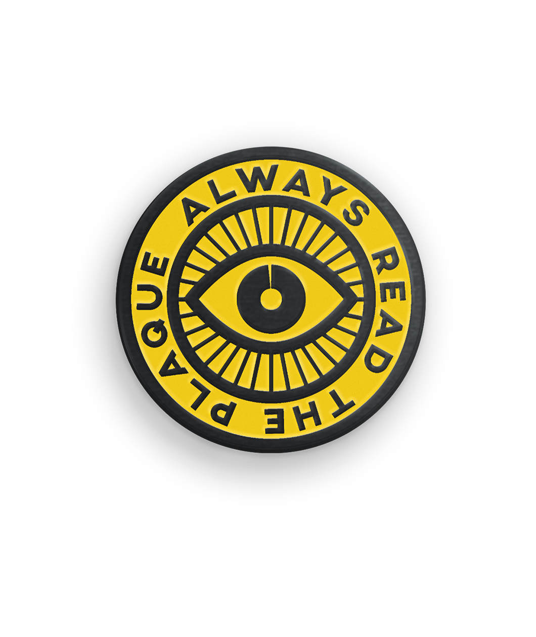 Yellow and black circular pin with an eye in the center and the phrase 