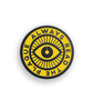 Yellow and black circular pin with an eye in the center and the phrase "Always read the plaque" surrounding it - by 99% Invisible