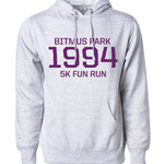 Heather white hoodie with large red 1994 in the front center and "Bitmus Park 5K Fun Run" sandwiched around it in smaller font. The hoodie has a front pocket on the bottom. 