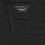 Close-up on a black pocket with the words "Dorian Smiles Inc." over a curved smile and the phrase "Why don't you join me?" in white. The phrase is repeated in undulating patterns of black ink underneath the white words. By Brian David Gilbert