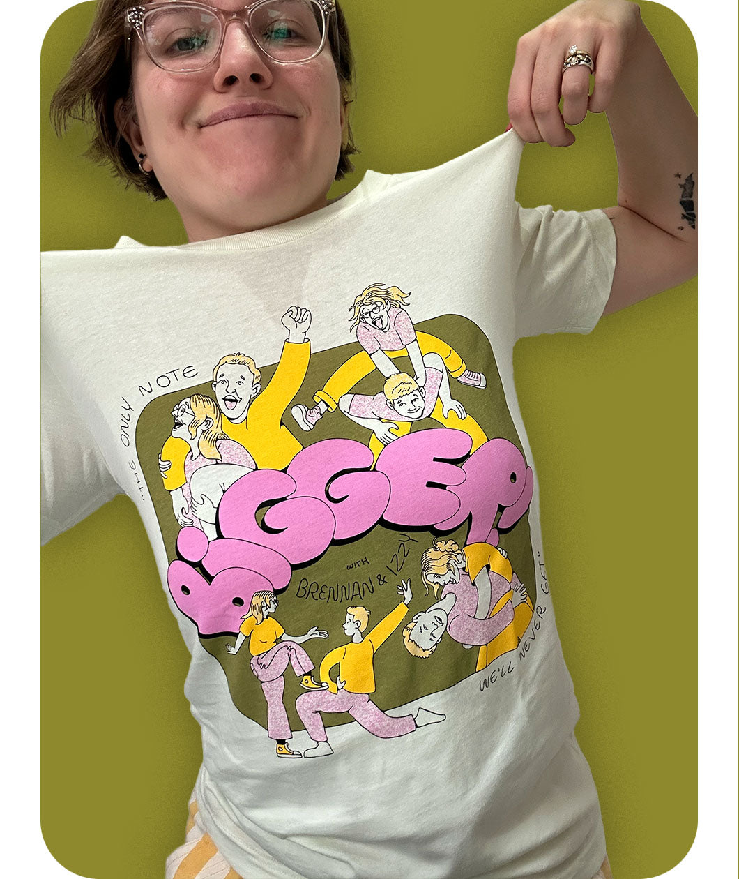 Izzy modeling the Izzy & Brennan's Shenanigans shirt against a green background.