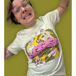 Izzy modeling the Izzy & Brennan's Shenanigans shirt with a funny face against a green background.