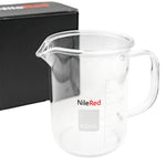 Clear beaker shaped mug with NileRed logo in front of a black box.