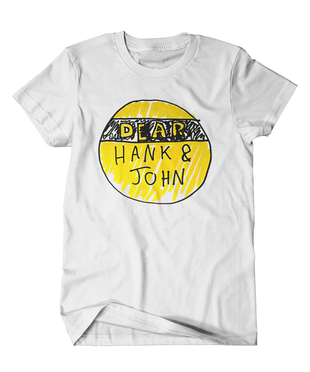 A mockup of an off-white t-shirt with a design featuring a hand drawn yellow and black Dear Hank & John logo.