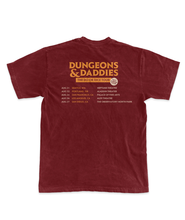 Back of burgundy t-shirt. Dungeons & Daddies logo in orange on top with DO OR DICE TOUR in an orange rectangle beneath it with the tour dates and locations beneath that.